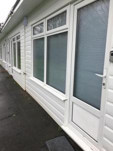 a row of windows with blinds on a building at Adventure Cabin in Dartmouth