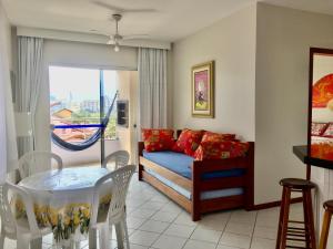 a living room with a couch and a table at Kasato Maru Residence 100 mts do mar ingleses norte in Florianópolis