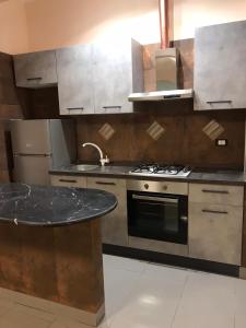 a kitchen with a stove and a counter top at Guest House Bracciano RM in Bracciano