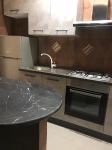 a kitchen with a marble counter top and a stove at Guest House Bracciano RM in Bracciano