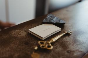 a key sitting on top of a table with a book at Ayiopetra Exclusive Getaways in K&aacute;to Sangr&iacute;on