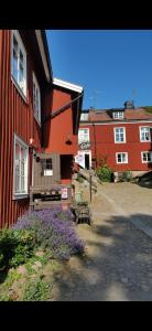un grupo de edificios con flores púrpuras al lado de un edificio en STF Hostel Mariestad, en Mariestad
