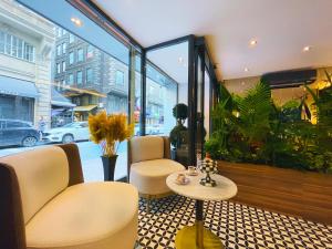 a room with two chairs and a table and a plant at Weingart Istanbul in Istanbul