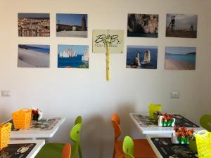 two tables in a room with pictures on the wall at B&b Paolo e Daniela in Carbonia