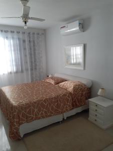 a bedroom with a bed and a ceiling fan at Itaúna saquarema beach house in Saquarema +75 photos