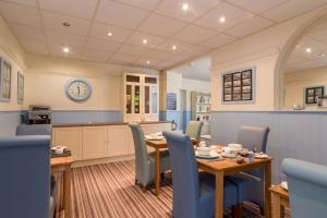 a kitchen and dining room with a table and chairs at The Fountaindale Skegness in Skegness +70 photos