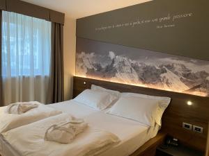Posteľ alebo postele v izbe v ubytovaní Dolomeet Boutique Hotel
