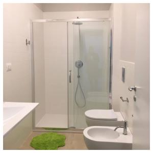 een badkamer met een douche, een toilet en een wastafel bij Elefante appartamenti in Pescara
