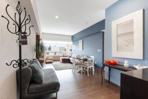 a living room with a couch and a dining room at Parque Sur Beautiful apartment 2 BE - 2 BA - 2 Parkings in Mexico City