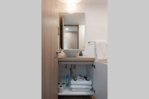 a bathroom with a sink and a mirror at Parque Sur Beautiful apartment 2 BE - 2 BA - 2 Parkings in Mexico City +28 photos