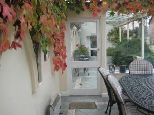 an open door to a patio with a table and chairs at Altonlea Lodge in Hartlepool