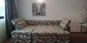 a couch in a living room with two zebras at Seaview apartment - Clara Sarafovo - 100m to sea in Burgas City