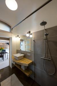 a bathroom with a sink and a shower at Stylish Studio Apartment in the Heart of Riga in Riga