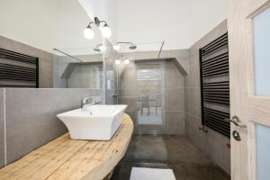 a bathroom with a white sink and a mirror at Stylish Studio Apartment in the Heart of Riga in Riga