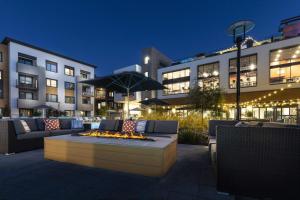 a patio with a fire pit in front of a building at Luxury Condos at Anton Menlo w Pool & Amenities in Menlo Park