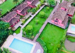 an aerial view of a house with a swimming pool at Chales Terra Pura in Camburi +11 photos