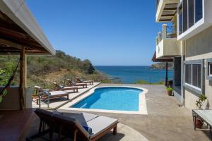 a swimming pool with a view of the ocean at Casa del Soul in San Juan del Sur