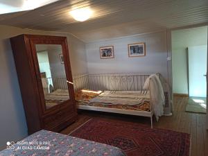 a bedroom with a bed and a large mirror at terre et mer in Sainte-Ramée