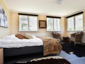 a bedroom with a large bed in a room with windows at Kolmårdsgården in Kolmården