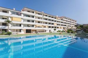 einem großen Pool vor einem Gebäude in der Unterkunft Vacation Home Studio Los Cristianos in Arona