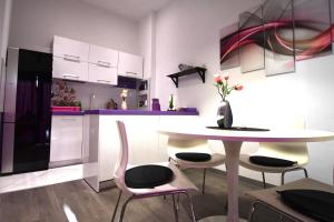 a kitchen with a table and two chairs and a table at Dubrovnik Icy Guest House in Dubrovnik
