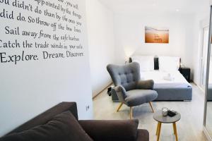 a bedroom with a bed and a couch and a chair at Dubrovnik Icy Guest House in Dubrovnik