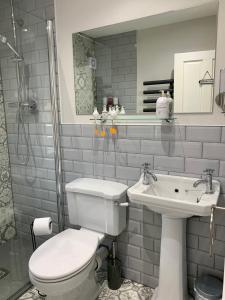 a bathroom with a toilet and a sink at Castle Cottage in Harrogate