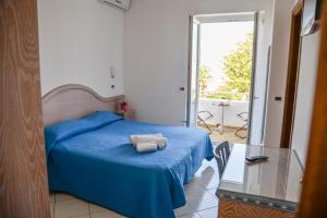 a bedroom with a blue bed and a glass table at Villa Erade in Casamicciola Terme +59 photos