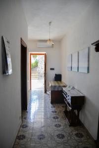 a hallway with a room with a piano and a table at Villa Erade in Casamicciola Terme