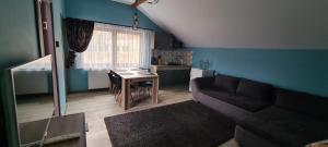 a living room with a couch and a table at Comfort Home Apartment 3 in Petroşani