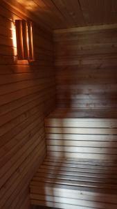an empty wooden sauna with a light in it at Norrvange Stugor in Kappelshamn