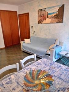 a living room with a table and a couch at Caletta Beach in Castiglioncello