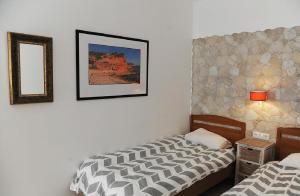 a bedroom with two beds and a mirror on the wall at Pension Subirats Perello in Perelló