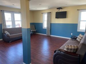 a living room with a couch and a flat screen tv at JD Apartment and House in Seaside Heights