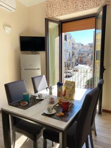 a table with chairs and a table with food on it at Casa Del Corso in Maletto +4 photos