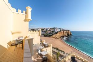 a balcony with a view of the ocean at Castelo Guest House in Carvoeiro