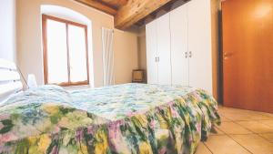 Un dormitorio con una cama con una colcha colorida. en Appartamenti San Francesco, en Lazise