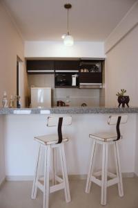 a kitchen with two bar stools at a counter at Dorrego l in Junín