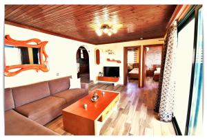 a living room with a couch and a table at Ardani paradise view villa with jacuzzi in Amoopi