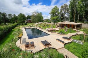 an overhead view of a pool with chairs and a house at Domaine de Ronchinne in Maillen