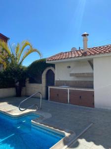 a house with a swimming pool next to a house at EPISKOPI VILLA, Luxury 4 Bedroom with Pool - Limassol in Limassol