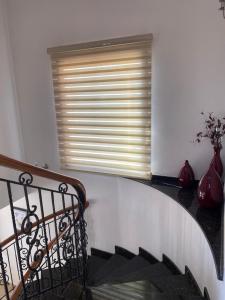 a staircase with a window and two vases at EPISKOPI VILLA, Luxury 4 Bedroom with Pool - Limassol in Limassol