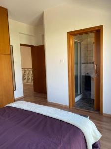 a bedroom with a bed and a large mirror at EPISKOPI VILLA, Luxury 4 Bedroom with Pool - Limassol in Limassol