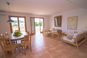 a living room with a dining room table and chairs at Apartment in Veli Losinj 36588 in Veli Lošinj