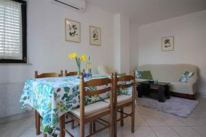 a dining room with a table and a couch at Apartment in Porec/Istrien 36682 in Poreč