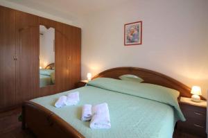 a bedroom with a bed with towels on it at Apartment in Porec/Istrien 36682 in Poreč