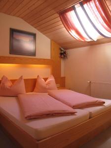 a bedroom with a large bed with a window at Apartments in Dienten am Hochkönig 225 in Dienten am Hochkönig
