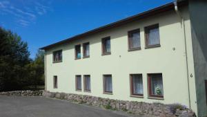 a white building with windows on the side of it at Apartments in Ribnitz-Damgarten 36531 in Altheide