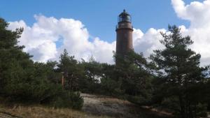 a lighthouse on top of a hill with trees at Apartments in Ribnitz-Damgarten 36531 in Altheide