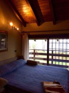 a bedroom with a large bed with a large window at Holiday home in Madonna Del Sasso 22866 in Madonna del Sasso